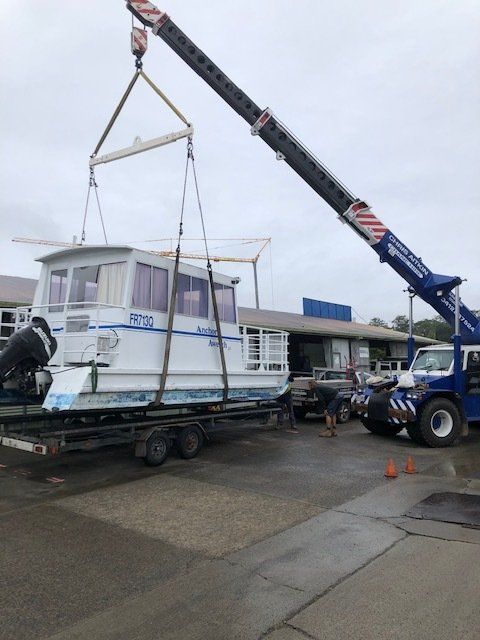 A Crane is Lifting a Boat on a Trailer — CA Crane Hire in Coolum, QLD