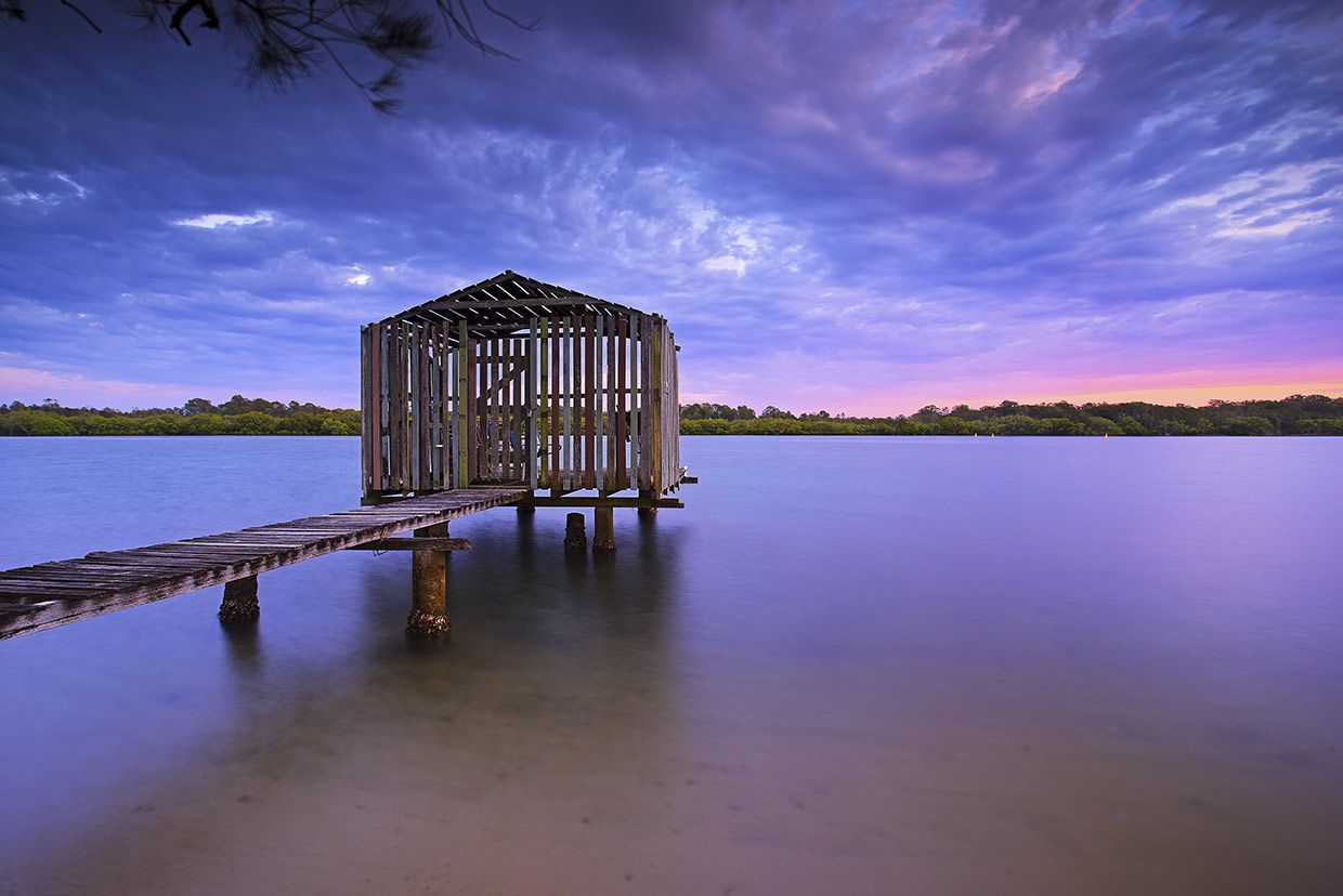 There is a Dock in the Middle of a Lake at Sunset — CA Crane Hire in Maroochydore, QLD