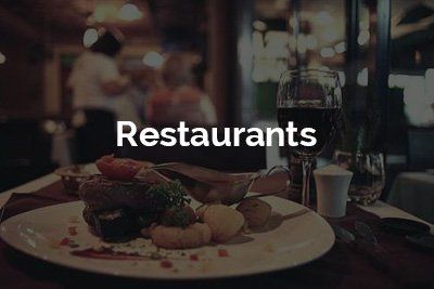 A restaurant with a plate of food and a glass of wine.
