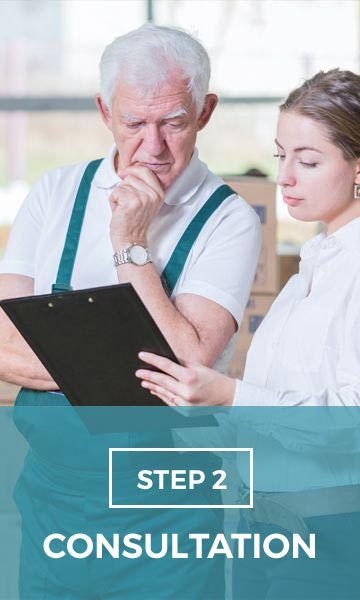 A man and a woman are looking at a clipboard.