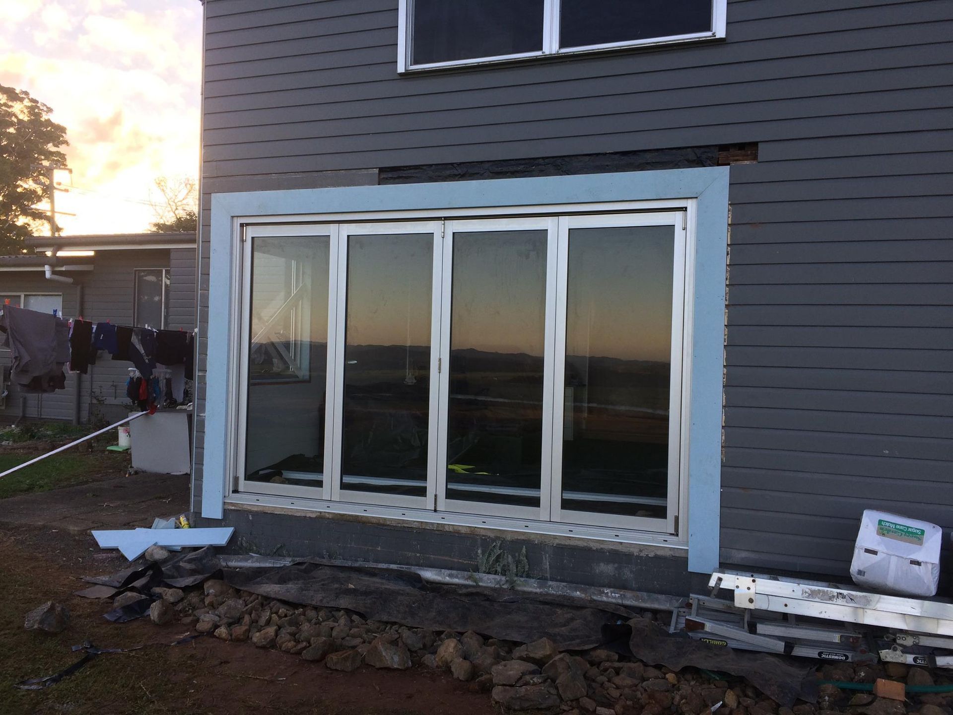 Exterior of a House With a Partially Installed Sliding Glass Door — Datco Windows & Doors Pty Ltd In South Brisbane, QLD