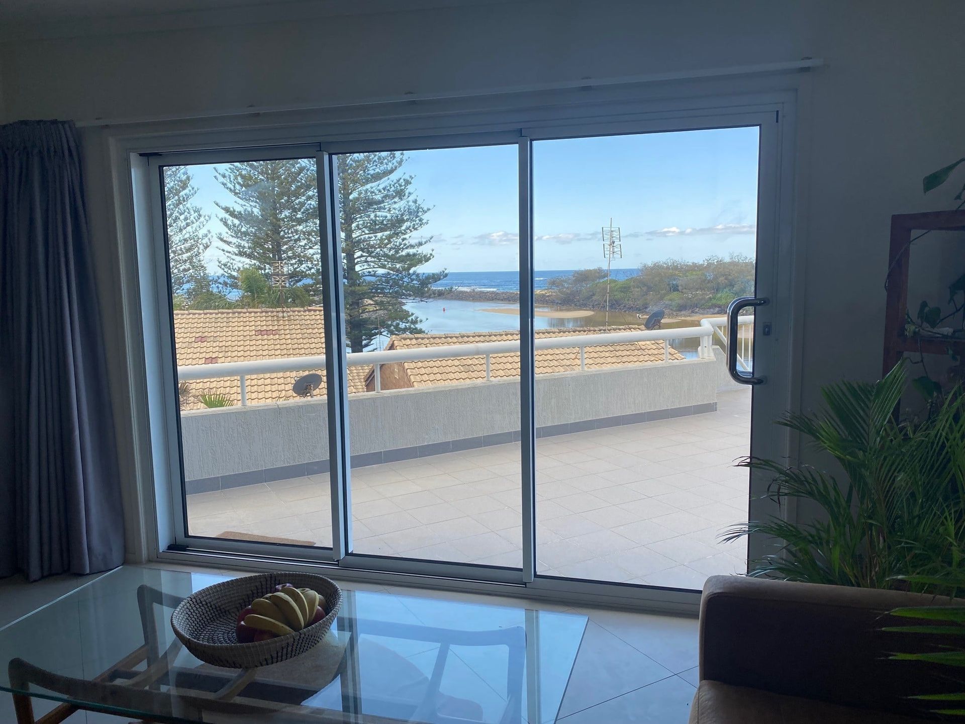 Sliding Glass Door Overlooking a Beach and Ocean — Datco Windows & Doors Pty Ltd In South Brisbane, QLD