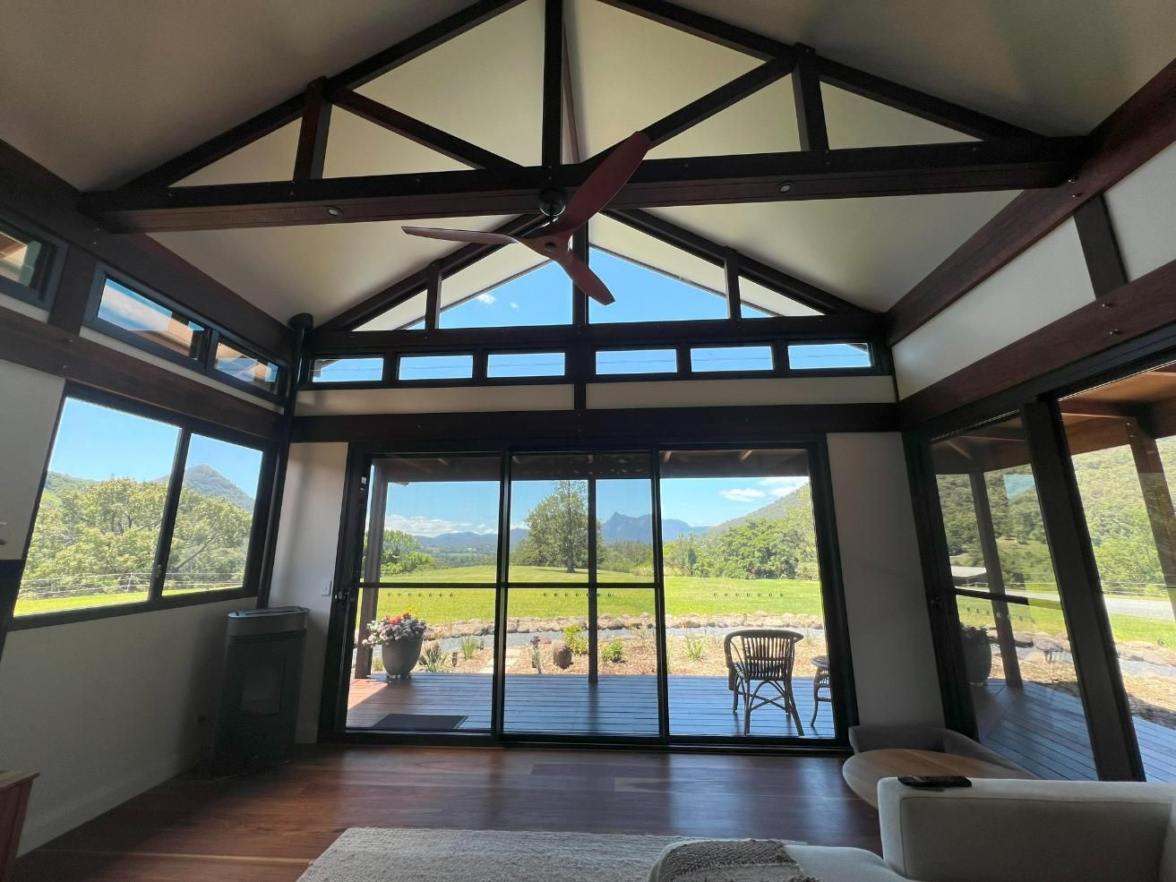 A Living Room With A Lot Of Windows And A Ceiling Fan — Datco Windows & Doors Pty Ltd In Kyogle, NSW