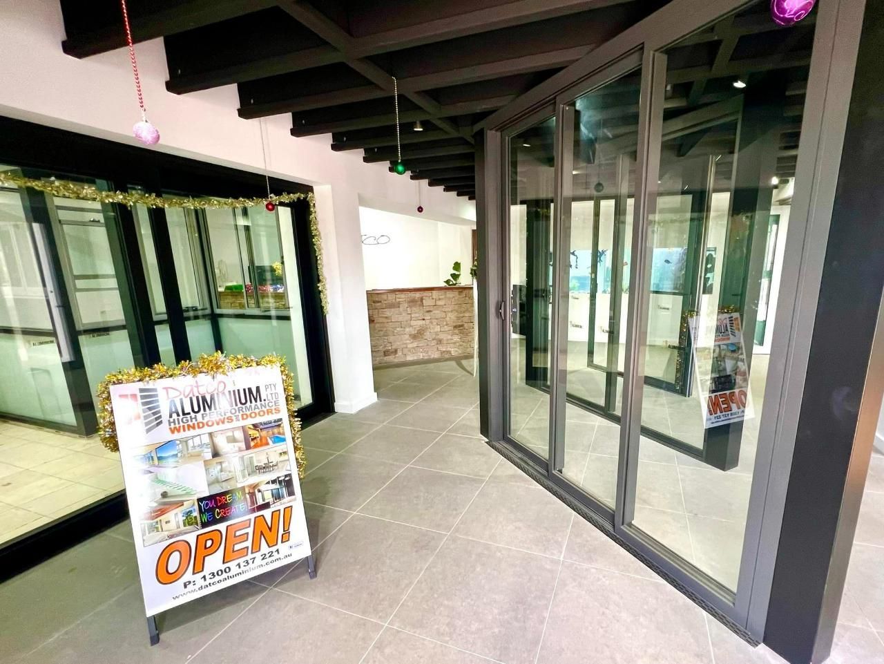 There Is A Sign That Says Open In The Middle Of A Hallway — Datco Windows & Doors Pty Ltd In Yamba, NSW