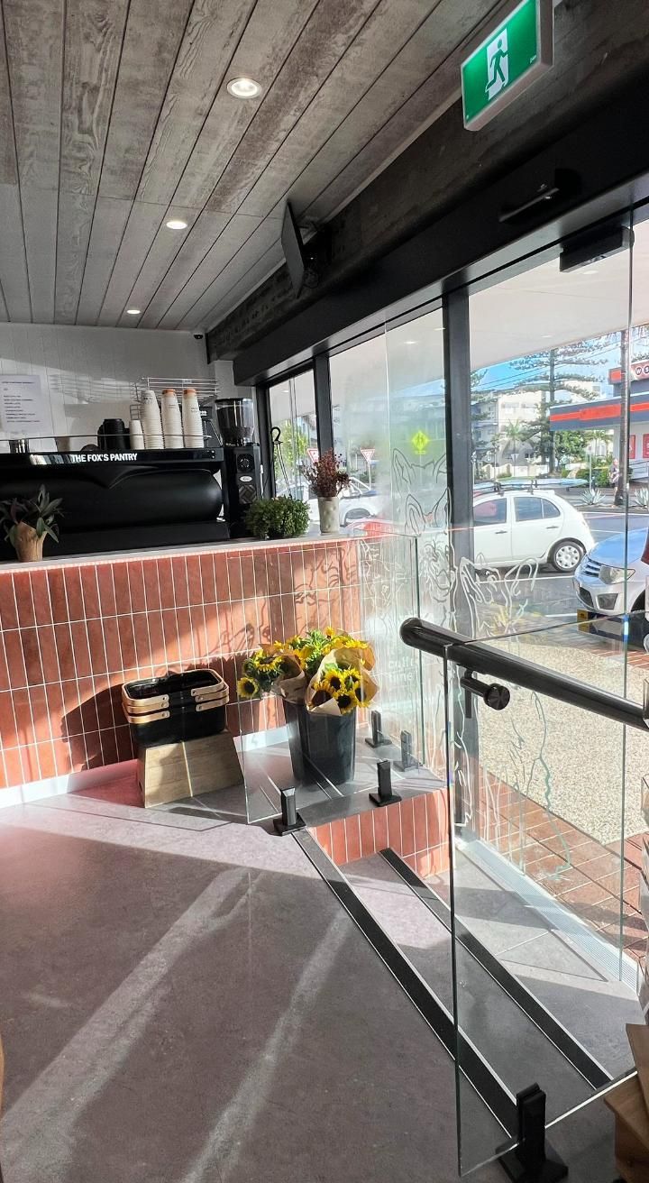 A Restaurant With A Lot Of Windows And Flowers On The Counter — Datco Windows & Doors Pty Ltd In Grafton, NSW