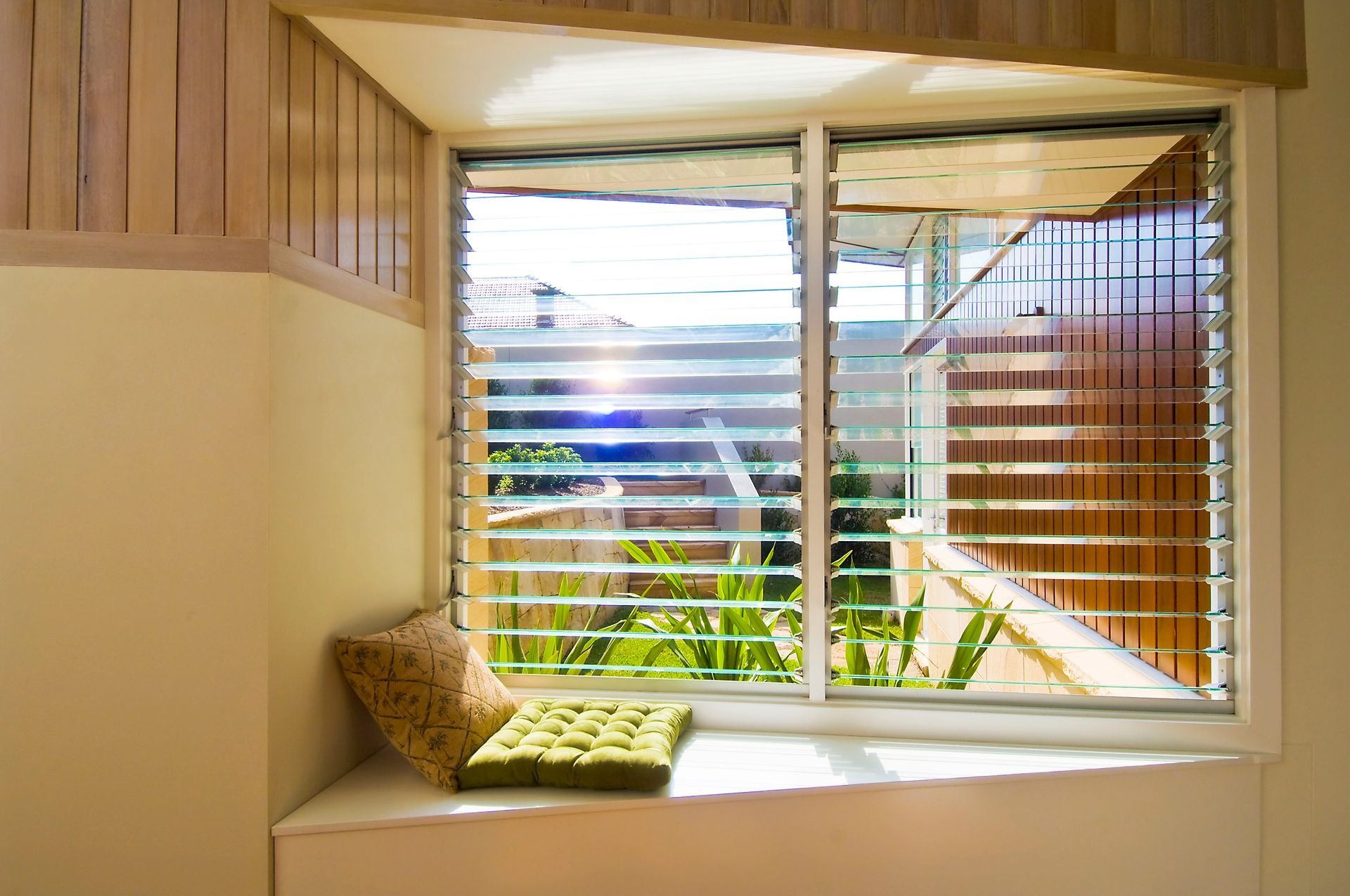 Window Seat With Glass Louvres and Pillows — Datco Windows & Doors Pty Ltd In South Murwillumbah, NSW