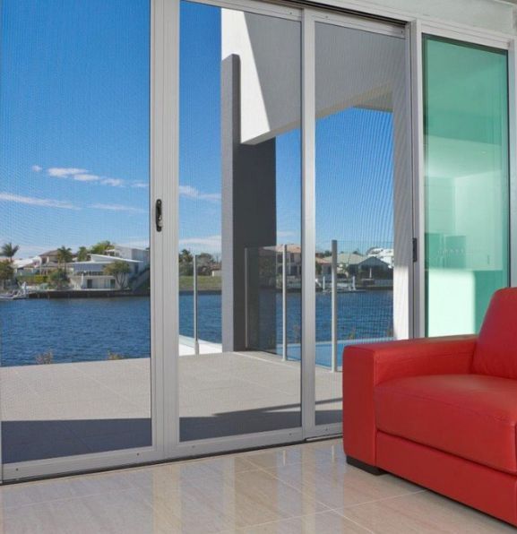 Modern waterfront living room with sliding glass doors — Datco Windows & Doors Pty Ltd In South Murwillumbah, NSW