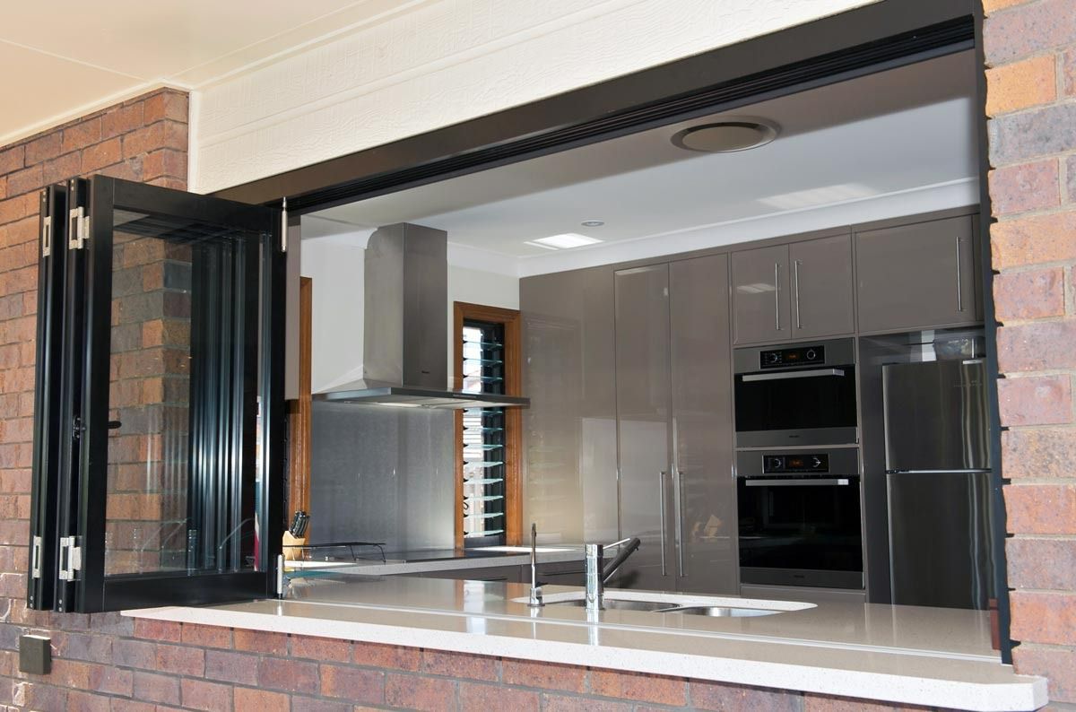 A Kitchen With Stainless Steel Appliances And A Large Window — Datco Windows & Doors Pty Ltd In South Murwillumbah, NSW