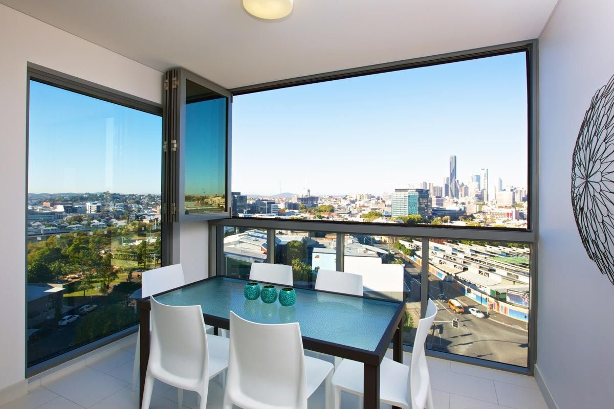 A Dining Room With A Table And Chairs And A View Of A City — Datco Windows & Doors Pty Ltd In South Murwillumbah, NSW