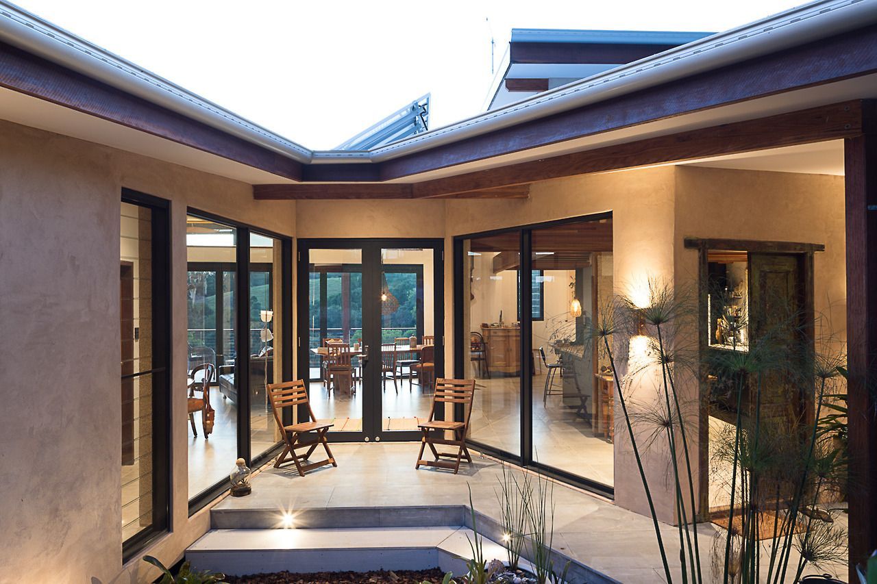 A House With a Lot of Windows and Chairs — Datco Windows & Doors Pty Ltd In South Murwillumbah, NSW