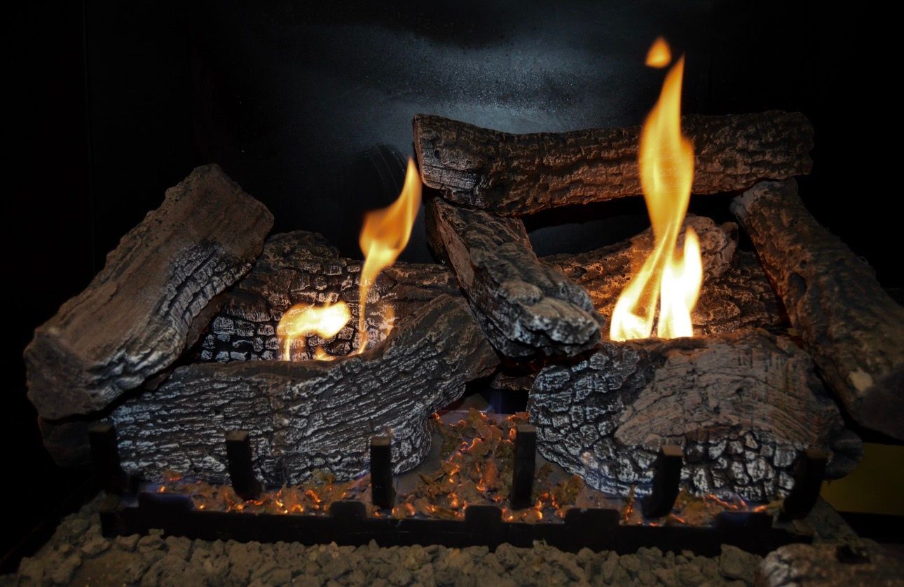 Burning logs in a fireplace with bright orange flames