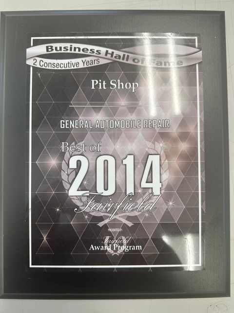 Framed award plaque for Pit Shop with 2014 and “Business Hall of Fame” text on a silver background