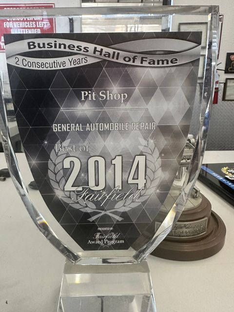 Business Hall of Fame glass award trophy with 2014 text on a table