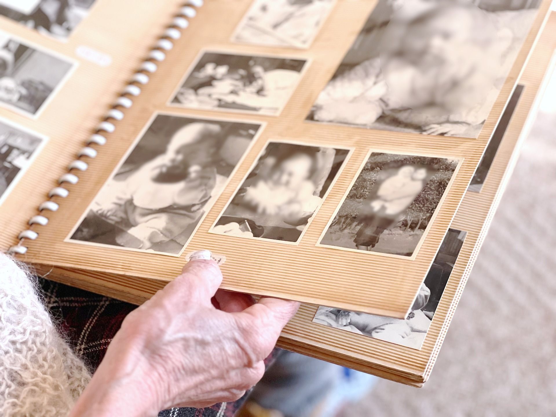 People looking at scrapbook of photos
