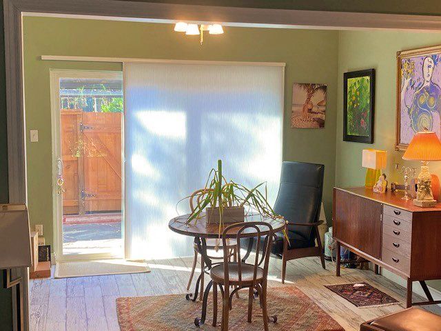 A living room with a table and chairs and a sliding glass door