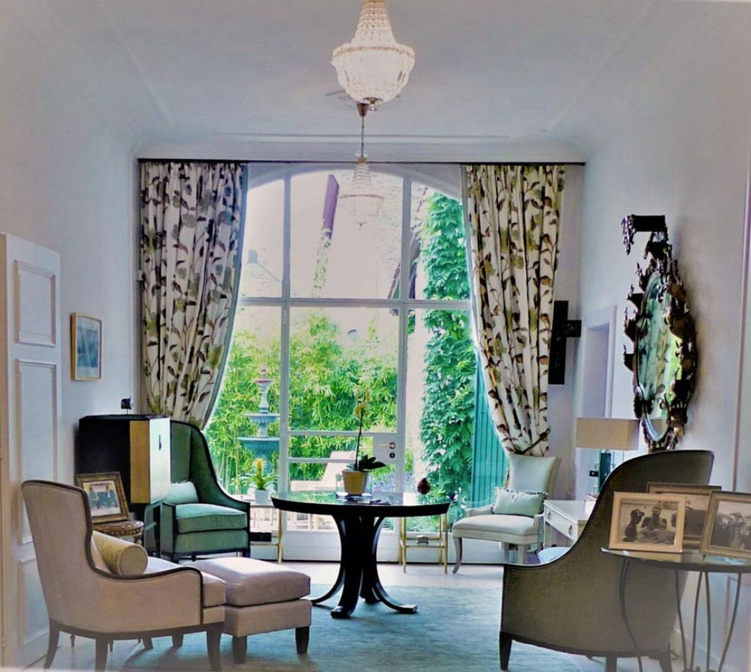 A living room with lots of furniture and a large window
