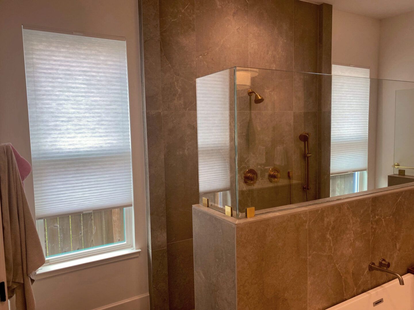 A bathroom with a walk in shower and a bathtub
