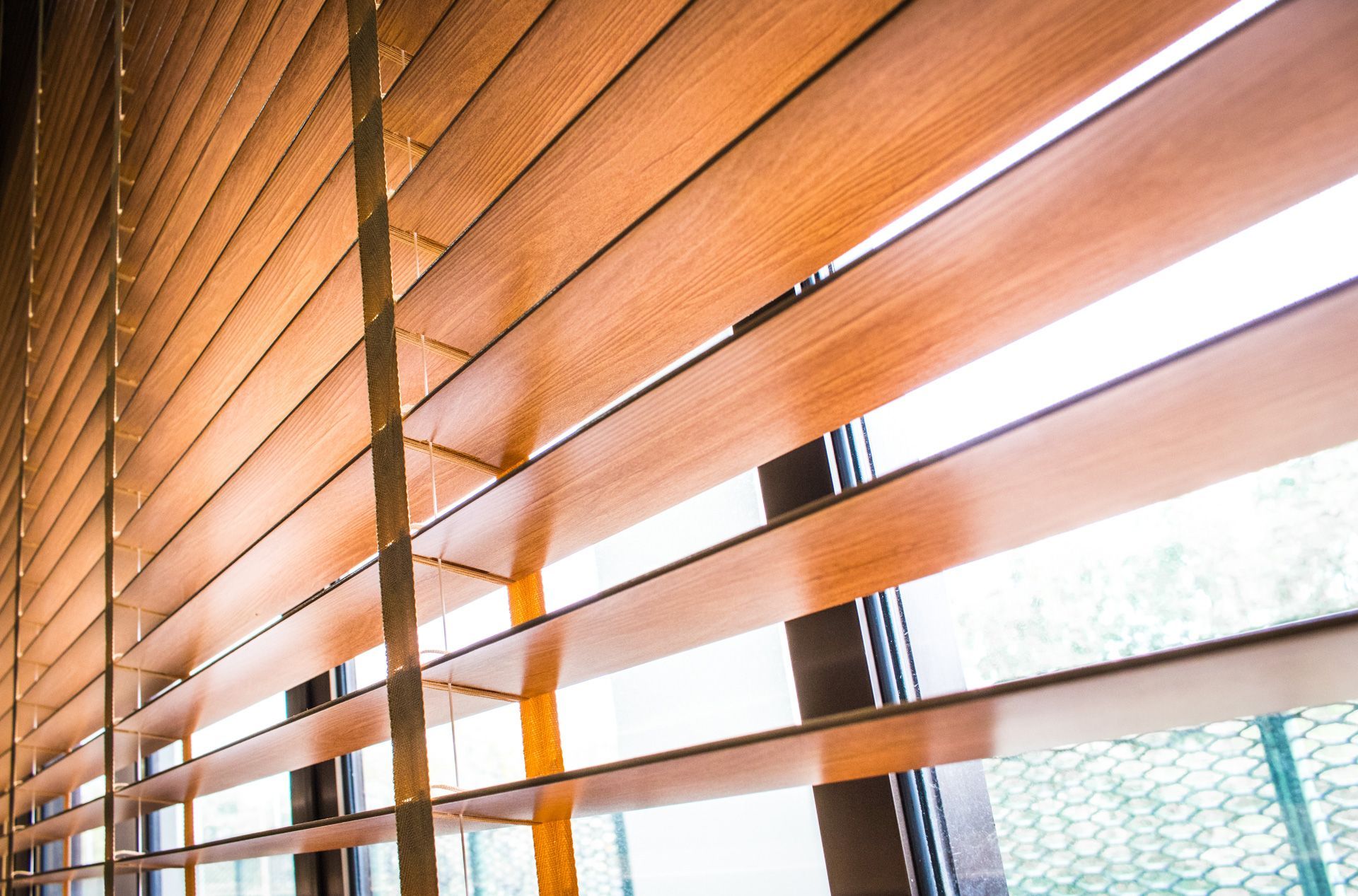 A close up of a wooden blind on a window