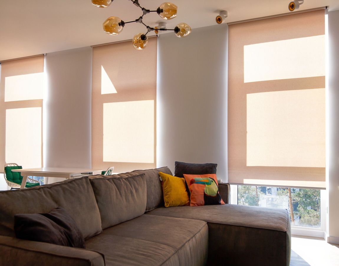 A living room with a couch and lots of windows