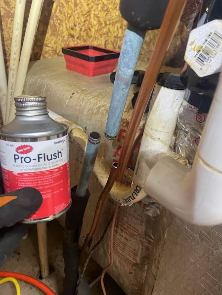 Tools and a Pro-Flush can in a cluttered workshop corner