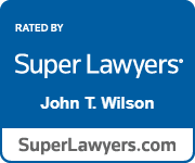 Super Lawyers John T. Wilson A blue sign that says Super Lawyers John T. Wilson