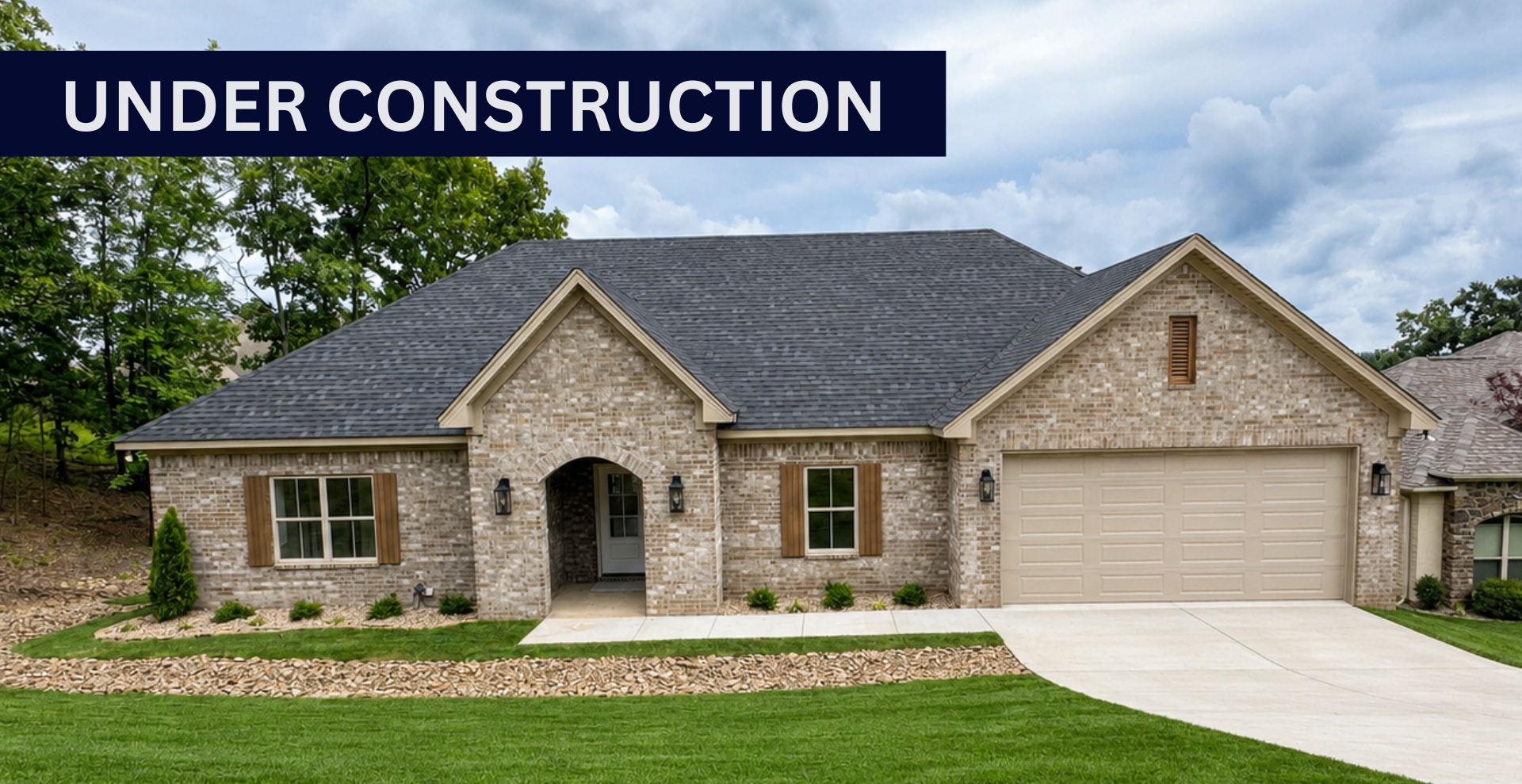 Simple custom home built by hines homes with dark brick and a white accent wall out front with a curved front porch