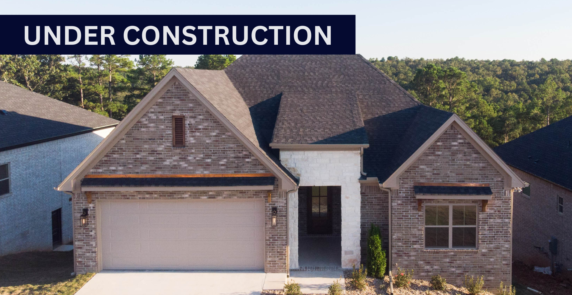 new construction home that is two story and lighter exterior colors. full of windows for natural light