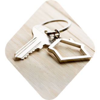 Photo of keys with a house keychain, all encapsulated in a diamond shape