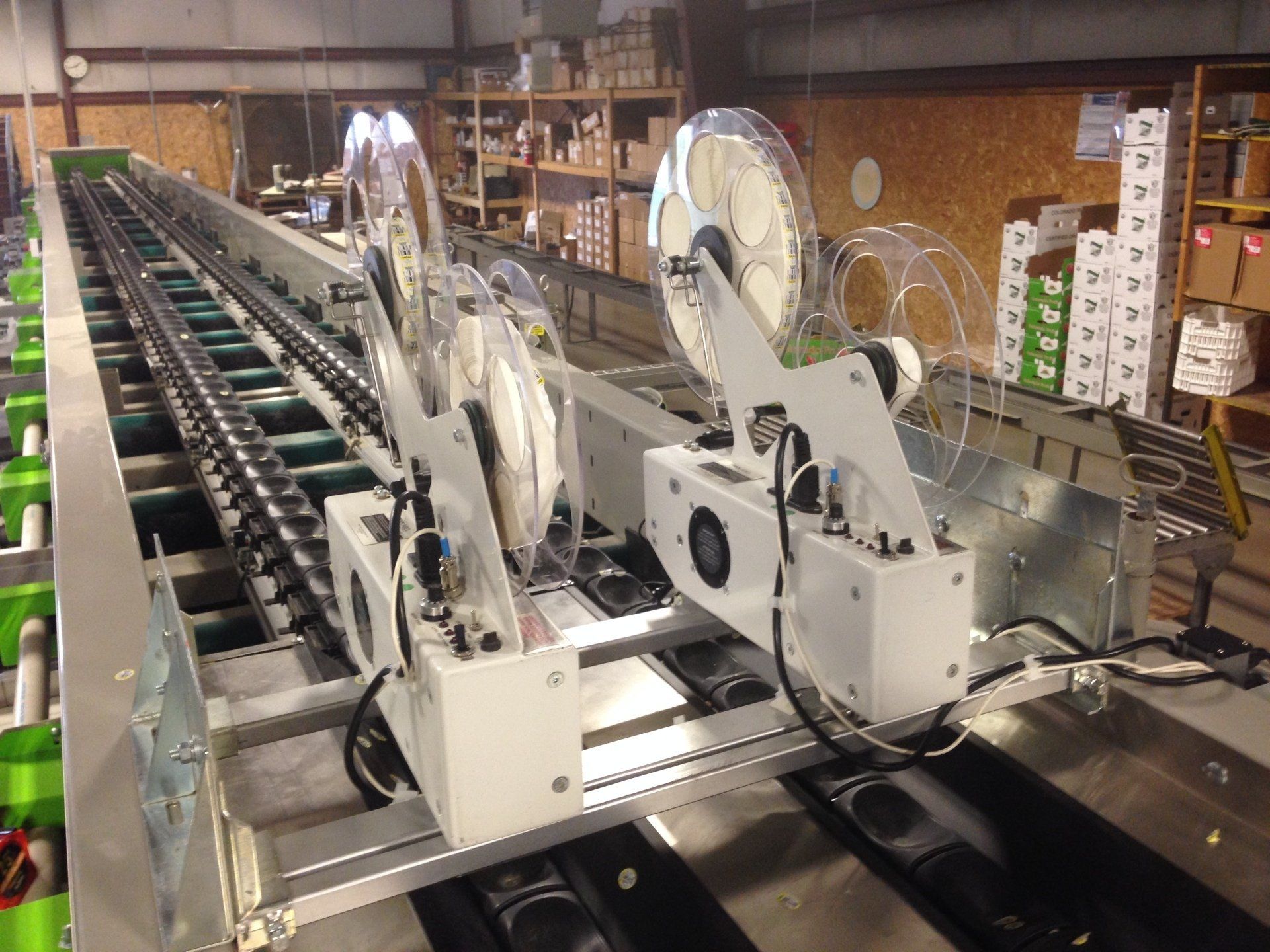 A machine is sitting on a conveyor belt in a warehouse.