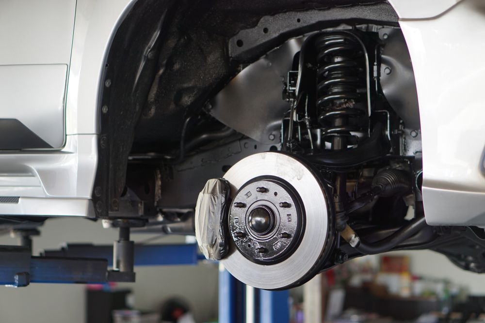 A Car Is Being Repaired On A Lift In A Garage — Valley Brake & Clutch In McDougalls Hill, NSW