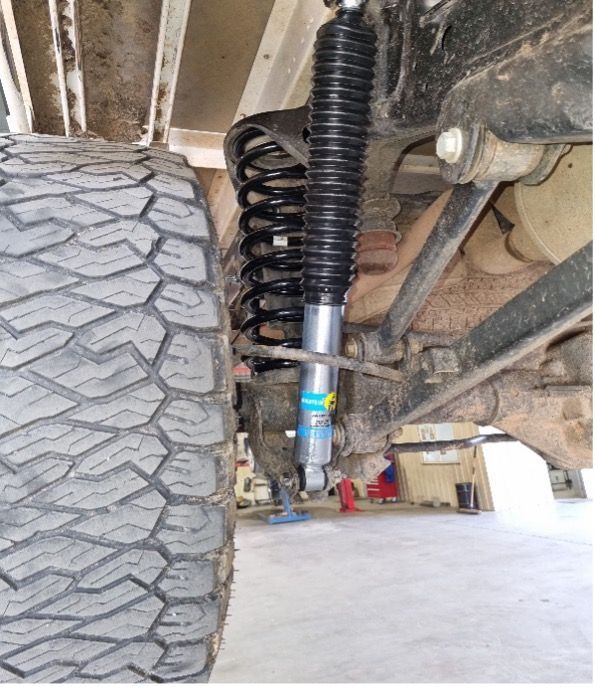 A Close Up of a Shock Absorber and a Tire on a Truck — Valley Brake & Clutch In McDougalls Hill, NSW