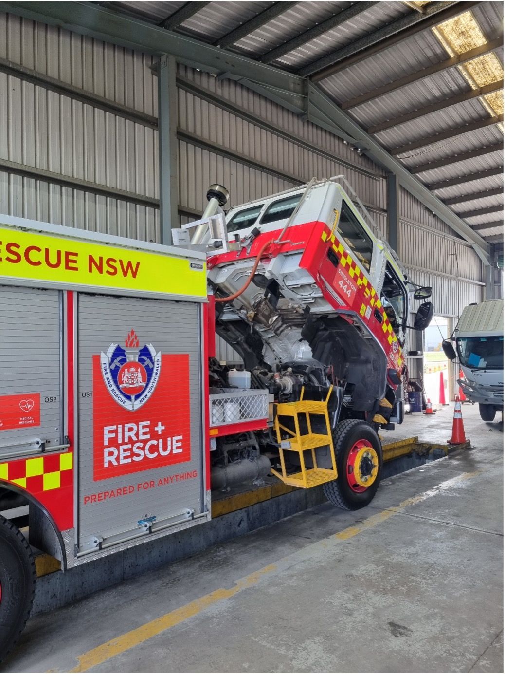 A Man Is Working On A Car With The Hood Open In A Garage — Valley Brake & Clutch In McDougalls Hill, NSW