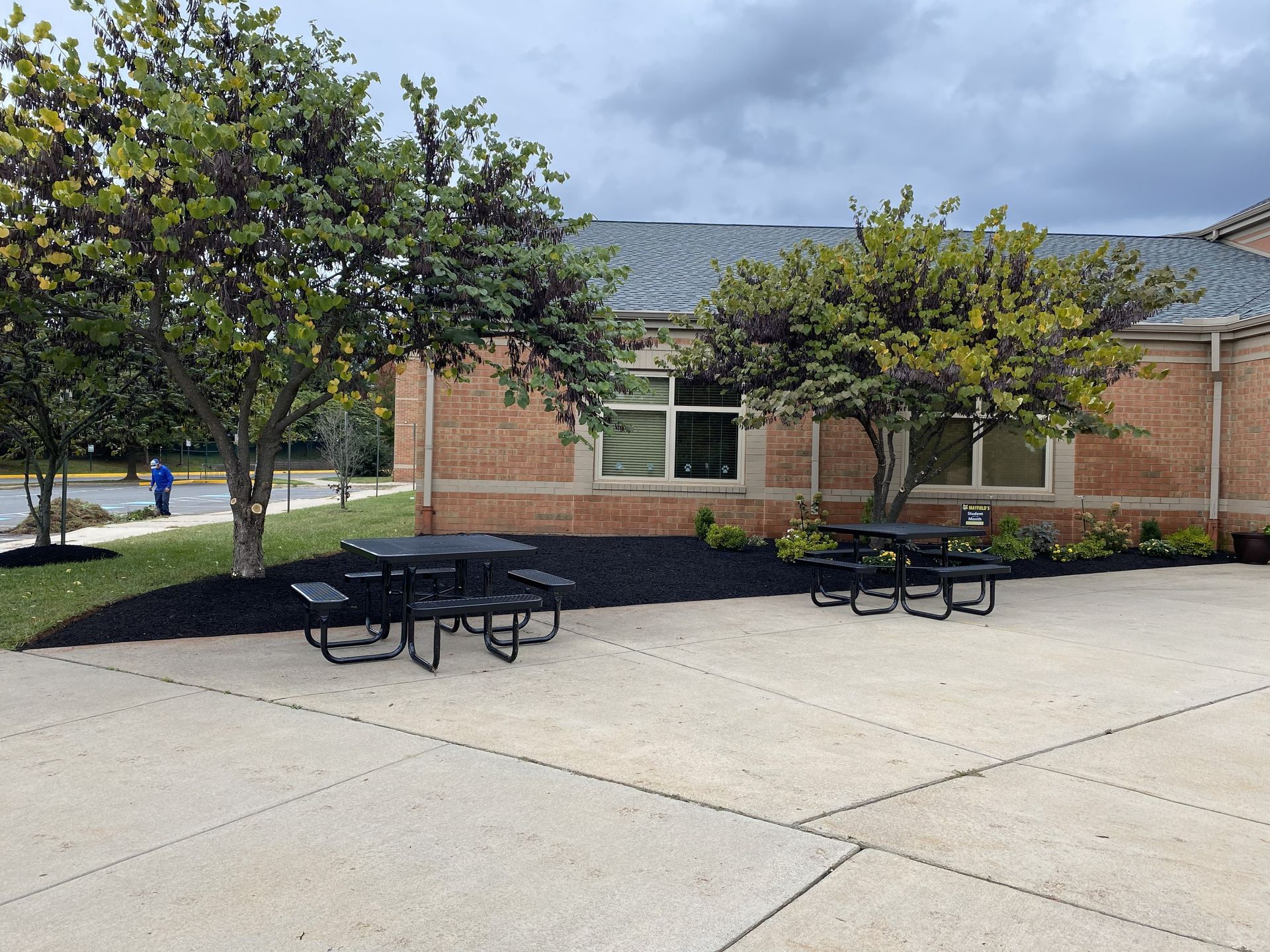 GreenWish Landscape & Masonry crew installing fresh black mulch to enhance a commercial property landscape in Northern Virginia.