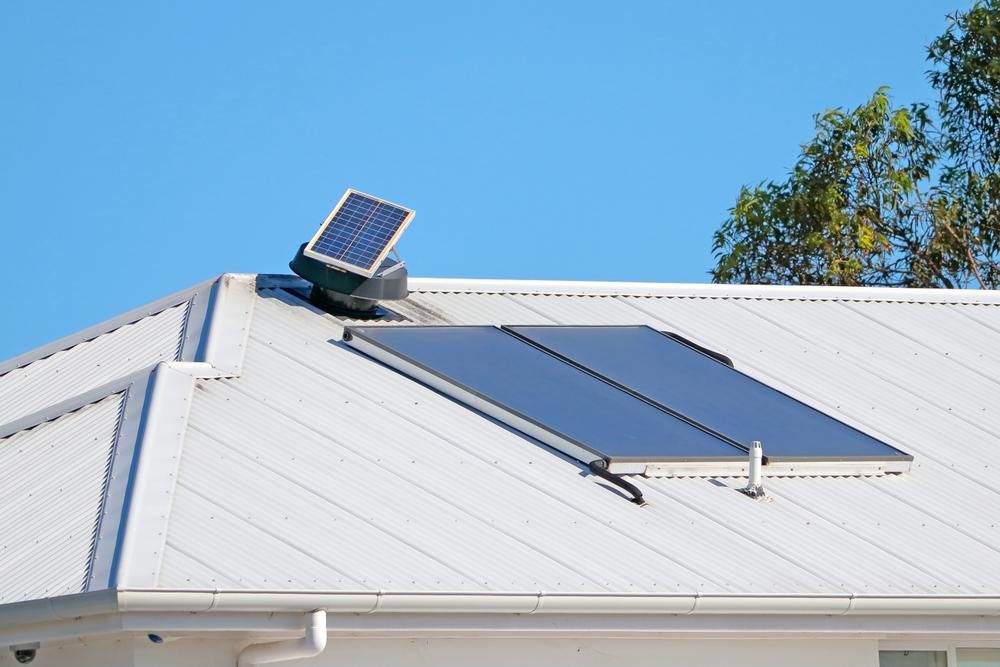 A White Roof With Two Solar Panels on It — Jet 'N' Drain Pty Ltd In Kawungan, QLD