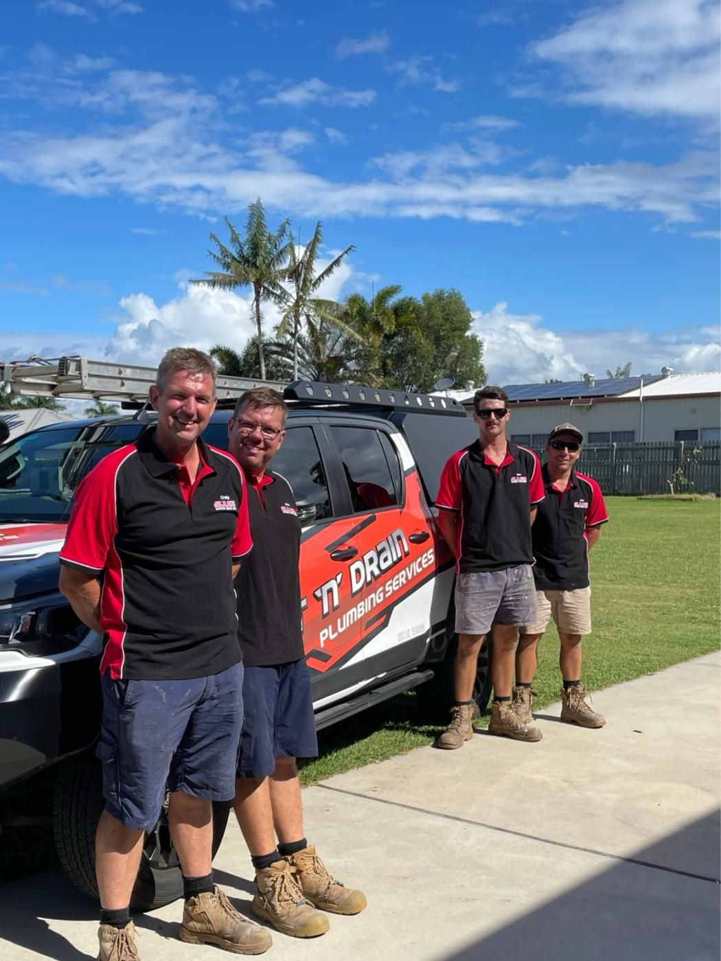 A Plumber is Giving a Clipboard to a Woman in a Kitchen — Jet 'N' Drain Pty Ltd In Kawungan, QLD