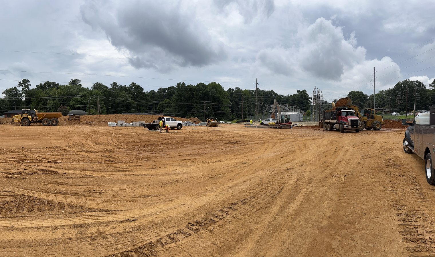 a truck is parked in the middle of a dirt field .