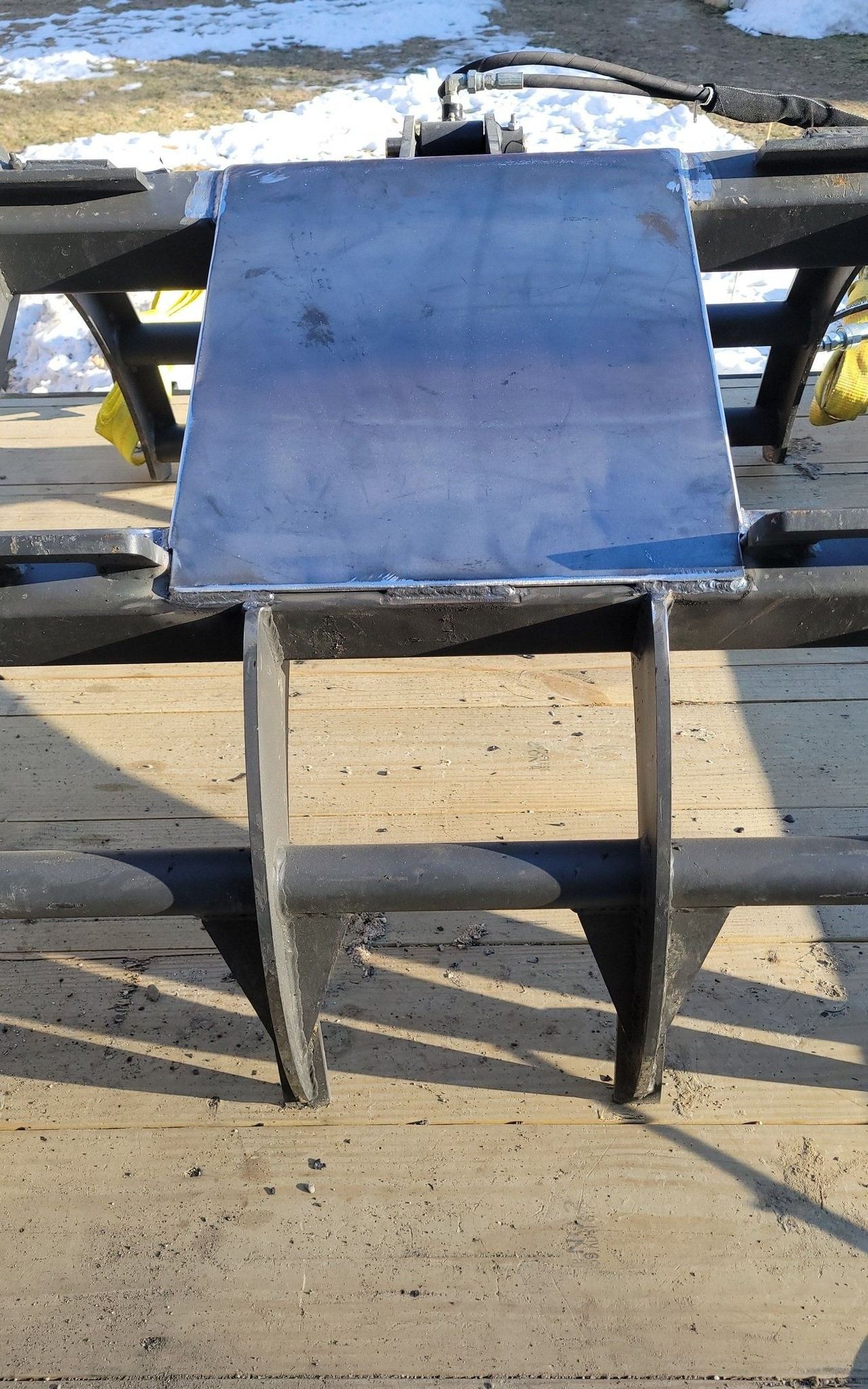 A piece of metal is sitting on top of a wooden table