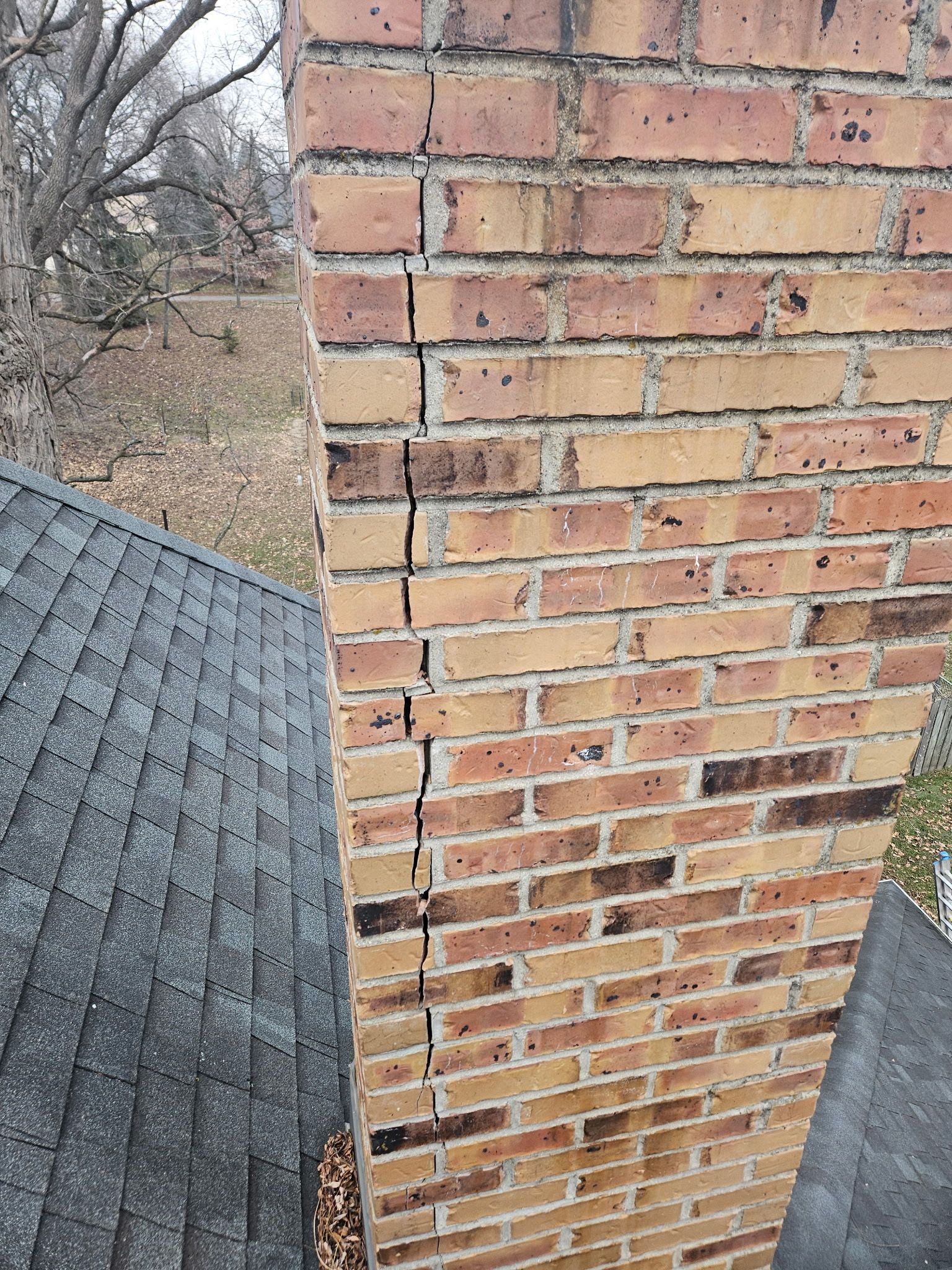 Brick chimney with a vertical crack.