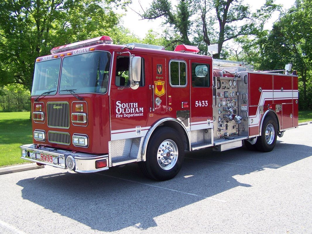 A red fire truck is parked on the side of the road