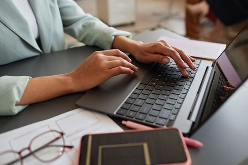 businesswoman using laptop and typing
