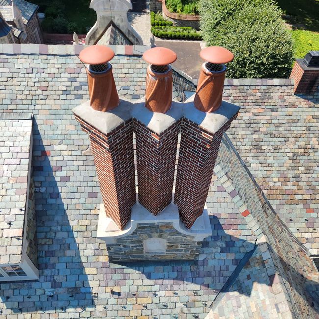 Mason rebuilding chimney with fresh brick and mortar JW Chimneys chimney sweep and inspection Montgomery County, Pennsylvania