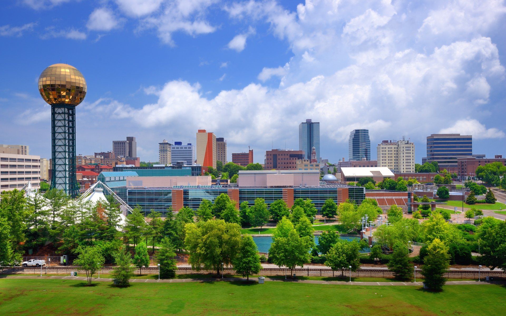 De skyline van Knoxville, Tennessee, met de gouden Sunsphere en gebouwen tegen een blauwe hemel.