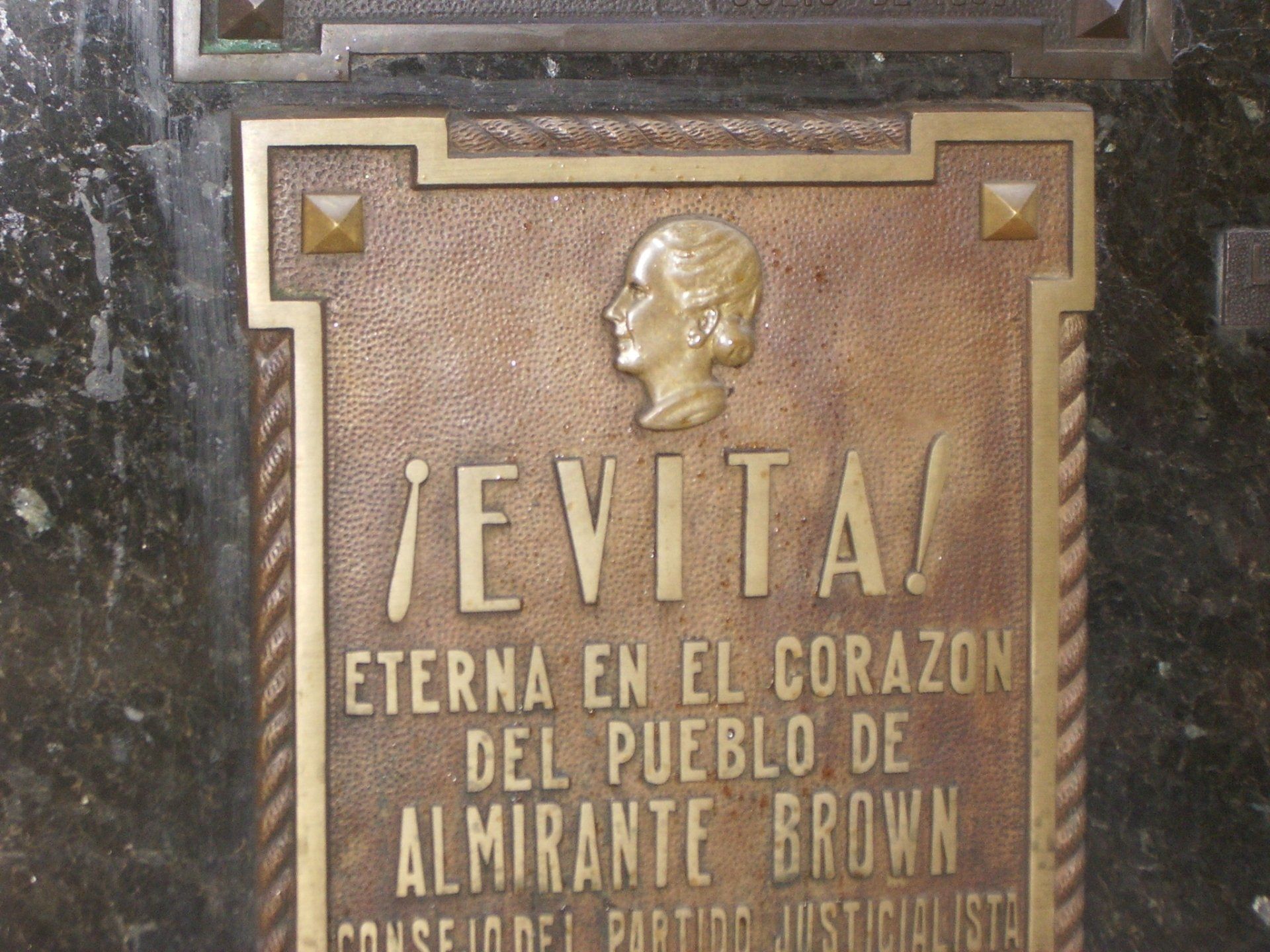 Bronzen plaquette van Eva Perón met de tekst 