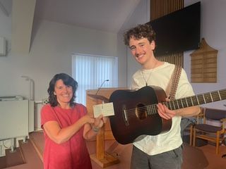 Morpeth Music Society 2025 MMS chair Wendy Locks presenting scholarship cheque to Euan Gibson