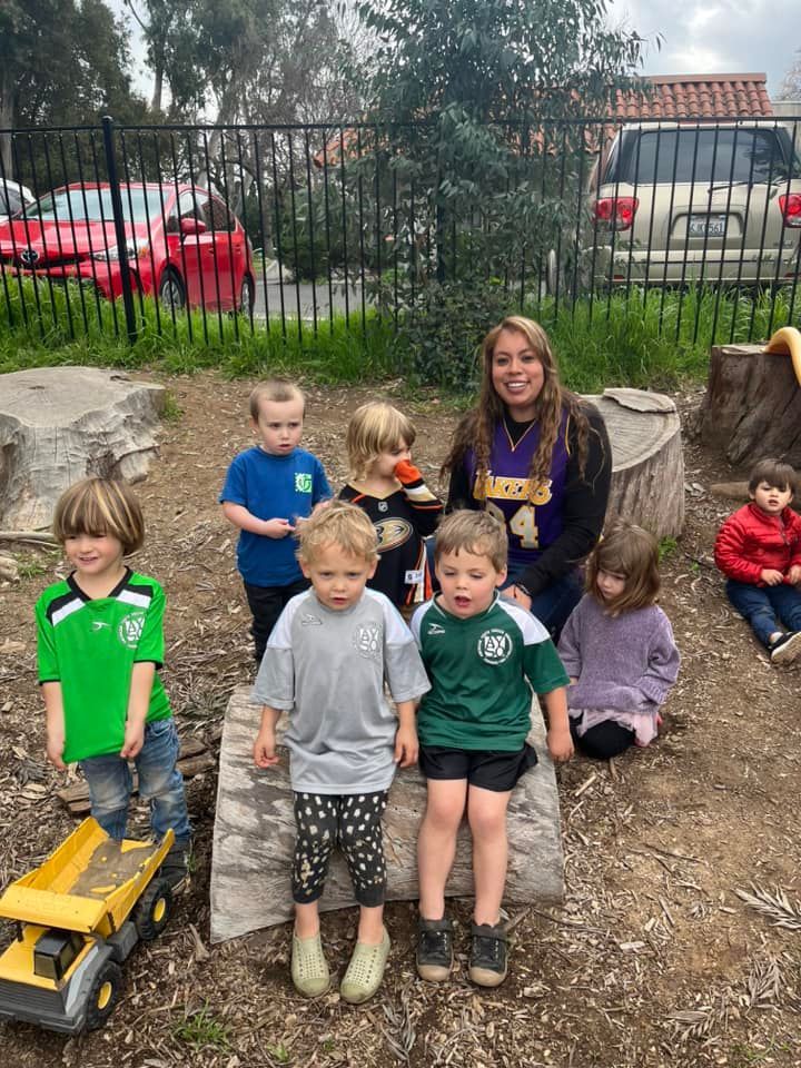 A group of children are posing for a picture in a playground.
