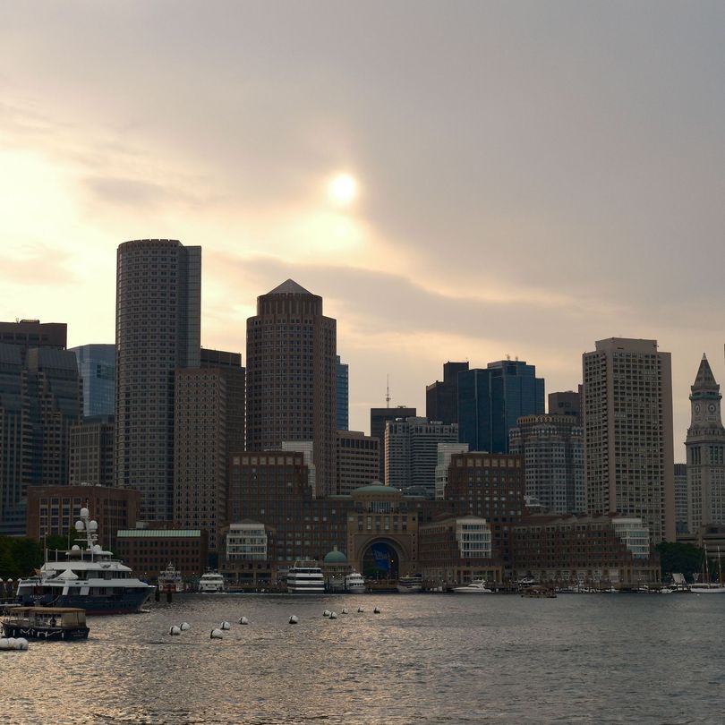 A river runs through a city surrounded by tall buildings
