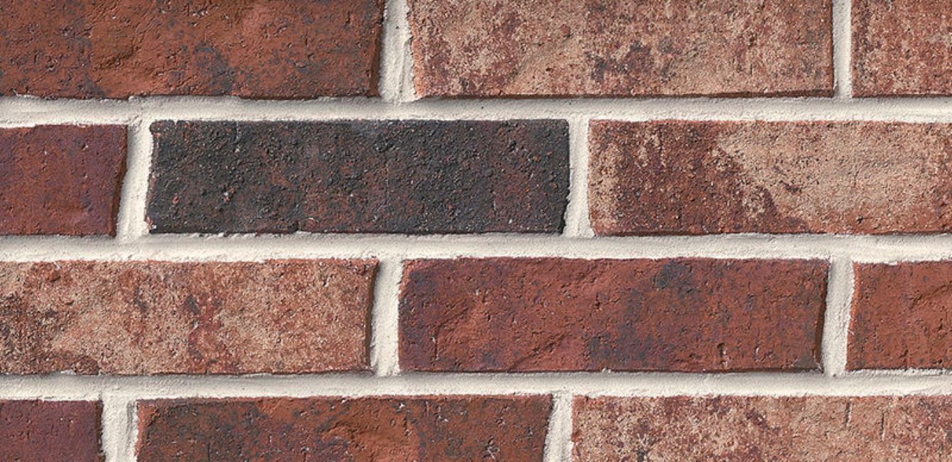 A close up of a brick wall with a lot of bricks on it.