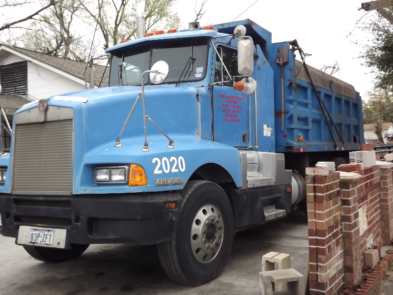 A blue dump truck with the year 2020 on the side