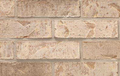 A close up of a brick wall with a lot of bricks on it.