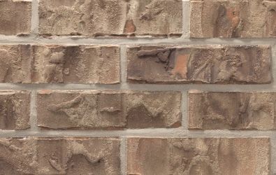 A close up of a brick wall with a lot of bricks on it.
